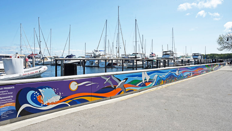 Mural at Northport Michigan Marina. Bold colors segue into water scenes. Design by Kat Dakota
